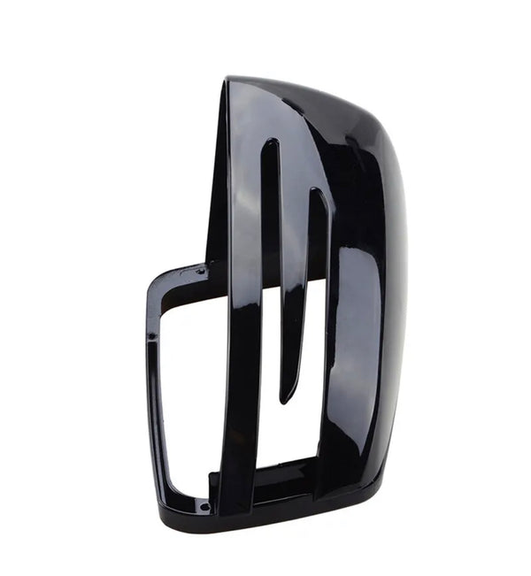 A glossy black plastic cover, featuring vertical slits, is shown standing upright. It likely functions as a protective or decorative component for a vehicle's mirror or light assembly.