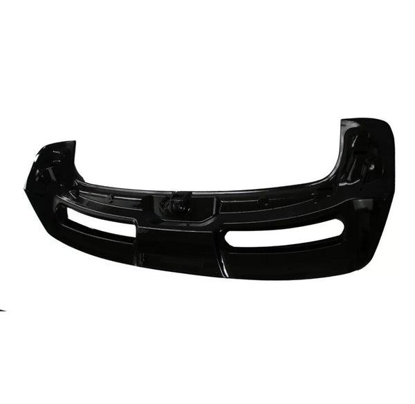 A black car bumper, featuring two large air vents, lies against a plain white background, highlighting its sleek, curved design.