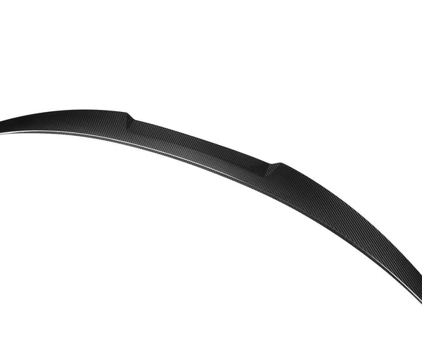 Curved carbon fiber car spoiler, sleek and aerodynamic, set against a plain white background.