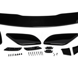 Car spoiler kit with black aerodynamic components laid out on a white surface. Includes a large wing, side pieces, and multiple small parts and screws for assembly.