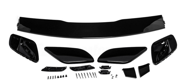 Car spoiler kit with black aerodynamic components laid out on a white surface. Includes a large wing, side pieces, and multiple small parts and screws for assembly.