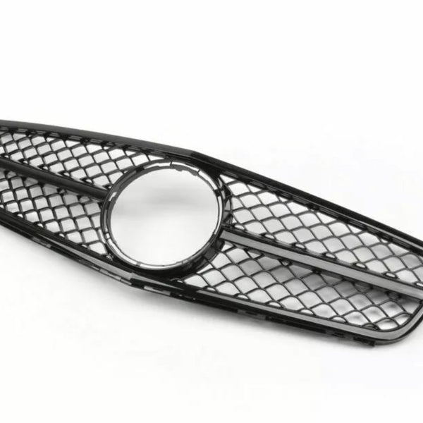 A black car grille with a diamond-patterned mesh and a circular center frame lies on a plain white background.
