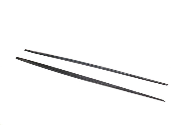 Two black chopsticks lie parallel, slightly spaced apart, on a white background. The chopsticks appear smooth and uniformly tapered towards the ends, set in a simple, minimal context.