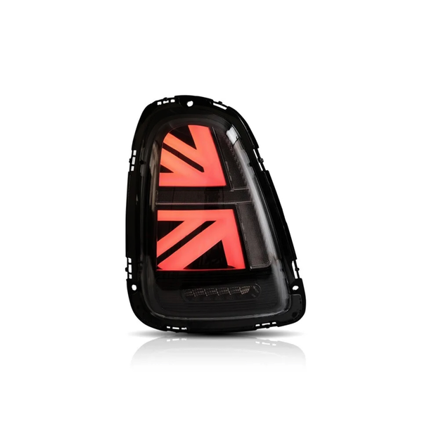 A car taillight featuring red LED lights shaped like a stylized Union Jack pattern, illuminated against a plain white background.