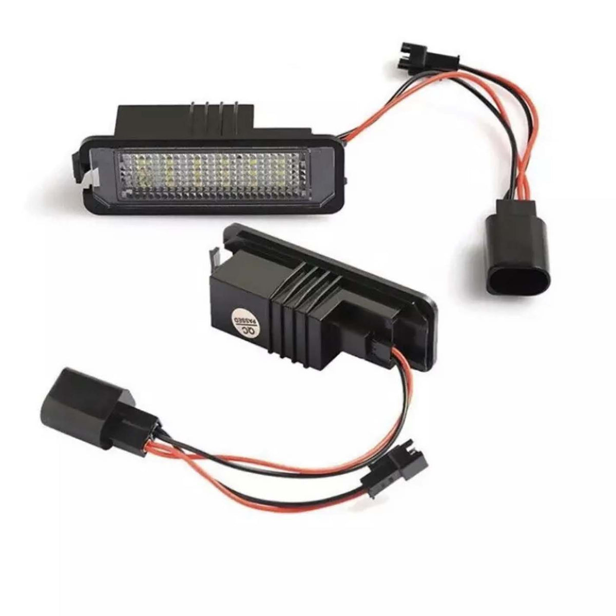 Two rectangular LED car lights connected by wires rest on a white surface. One light is face up, revealing numerous small LED bulbs. The other is slightly angled, showing its black casing.
