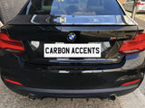 A black BMW car is parked in an outdoor setting, displaying a 