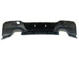 Black car bumper with cutouts for exhaust and mounting. The bumper is designed for rear attachment, featuring smooth contours and a flat backdrop, isolated on a plain white surface.