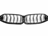 A glossy black car grille with vertical slats lies on a white background, resembling a butterfly shape with symmetrical slots, designed for vehicle front ventilation systems.