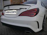 A white car with a Mercedes emblem and AMG badge is parked on a paved surface. The license plate reads, 