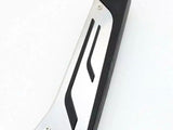 A black and silver utility knife handle lies diagonally on a white background, featuring two curved black grip lines and three visible screws securing the structure.