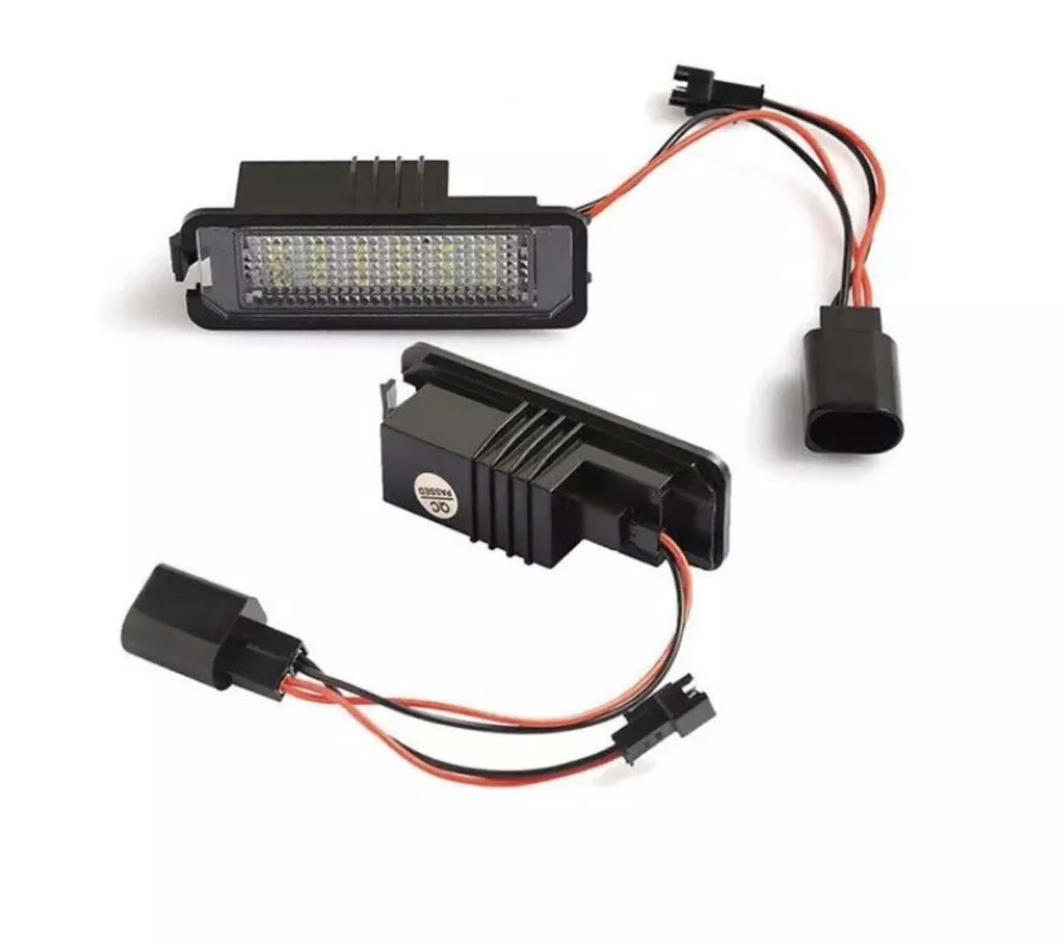 LED car lights featuring multiple small bulbs are connected by red and black wires to plastic plugs, set against a white background.