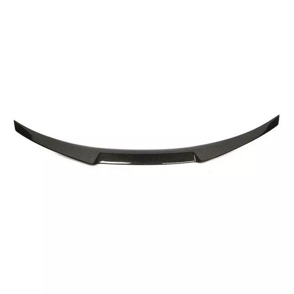 Curved, black carbon fiber car spoiler with a sleek design, resting against a plain white background.