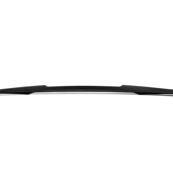 A sleek, black carbon fiber car spoiler with a slight curve sits against a plain white background, showcasing its aerodynamic design.