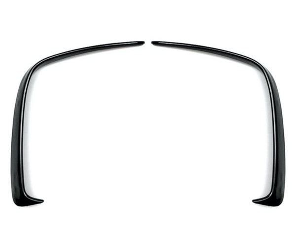Two curved black plastic fender flares symmetrically facing each other, positioned on a plain white background.