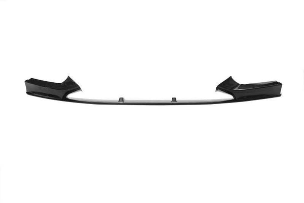A black car front splitter lies flat against a white background, featuring aerodynamic fins and smooth, angled design elements on each end.