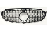 A car grille features vertical and horizontal chrome slats forming a grid pattern, with a circular emblem space in the center, set against a plain white background.