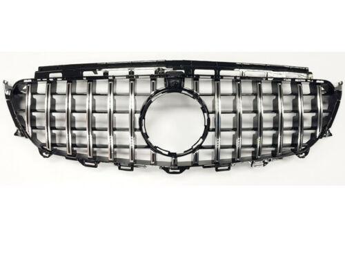 A car grille features vertical and horizontal chrome slats forming a grid pattern, with a circular emblem space in the center, set against a plain white background.