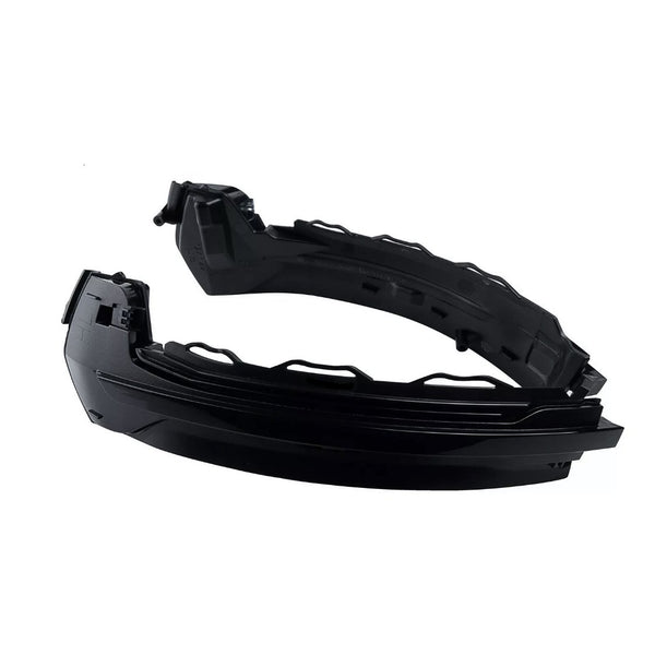 Black, curved car headlight assembly with sleek design, positioned diagonally. It features intricate detailing and mounting brackets, set against a plain white background.
