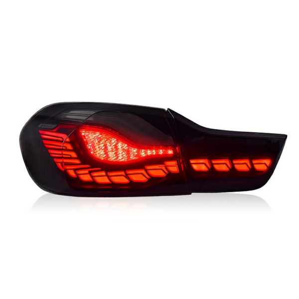 A car taillight, illuminated with bright red LED segments, is shown against a plain white background, highlighting its sleek design and detailing.