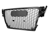 A black car grille features a honeycomb pattern with a blank, central oval plate, placed on a plain white background.