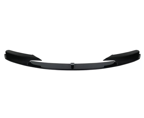 Black car front splitter with a glossy finish, featuring aerodynamic fins on both sides. It is isolated against a plain white background.