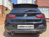 A black BMW M135i is parked on a driveway, featuring dual exhausts and a 