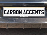Car rear end with dual exhaust pipes, carbon fiber diffuser, and a license plate reading 