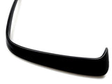 A black, curved car spoiler sits against a plain white background, highlighting its smooth, aerodynamic shape designed for enhancing vehicle performance.