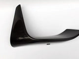 A black carbon fiber car spoiler is angled sideways against a plain white background, displaying its aerodynamic, curved shape and glossy finish.
