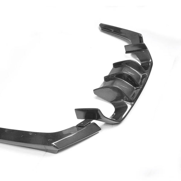 Carbon fiber car rear diffuser with multiple fins and curved edges, displayed against a plain white background, emphasizing its sleek and aerodynamic design.
