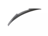 Curved carbon fiber car spoiler resting on a plain white background, designed to enhance vehicle aerodynamics.