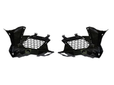 Two black metal brackets with honeycomb-patterned sections, positioned symmetrically facing each other, likely used in automotive assemblies, set against a plain white background.