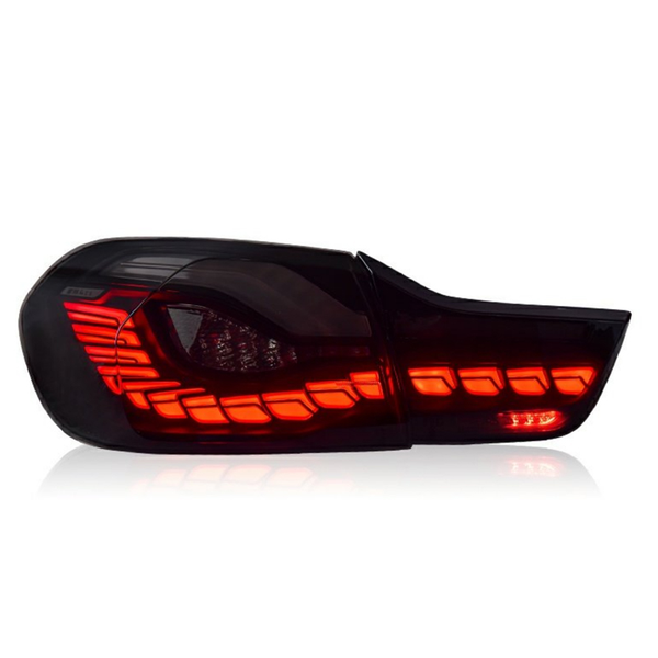A car taillight, illuminated with vibrant red LED lights in a sequence, is set against a plain white background, emphasizing its sleek, modern design.