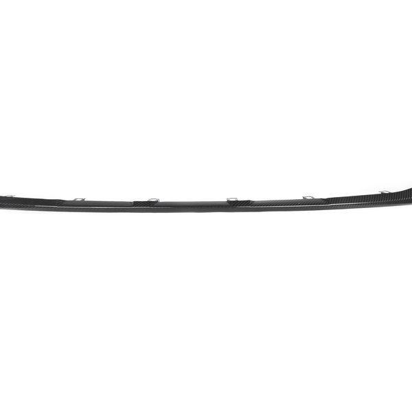 A black, curved automotive bumper spoiler is positioned horizontally against a white background, designed for aerodynamics with integrated attachment points.