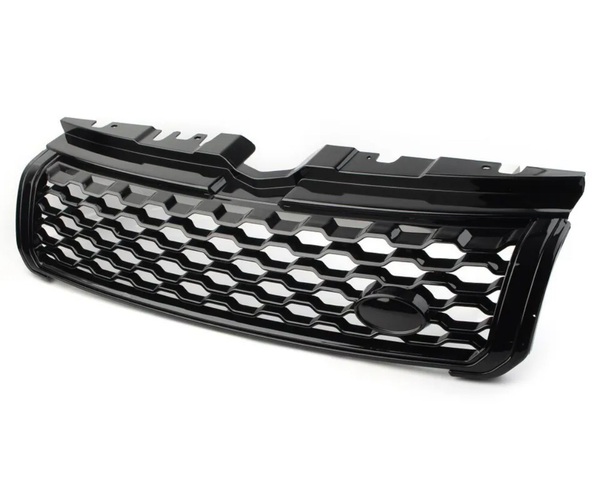 Black car grille with a honeycomb pattern, resting on a plain white surface, featuring a central oval space likely for logo placement, designed for front vehicle installation.
