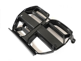 A black carbon fiber car grille, featuring multiple openings and a sleek design, rests on a plain white background.