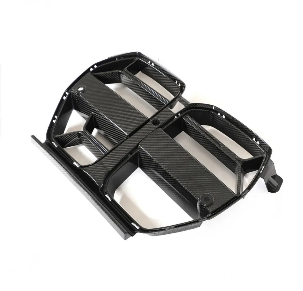 A black carbon fiber car grille, featuring multiple openings and a sleek design, rests on a plain white background.