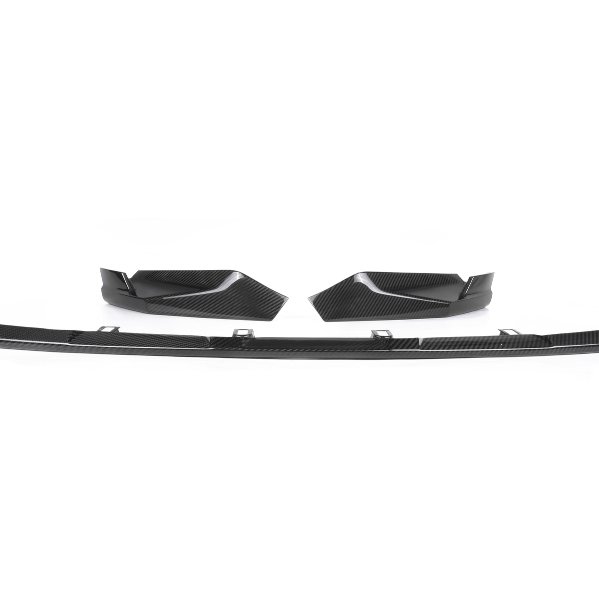 Carbon fiber car splitter and two side fins lie on a plain white background, showcasing their sleek, aerodynamic design intended for automotive performance enhancement.