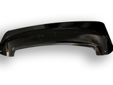 A glossy black plastic car fender lies on a white surface, with a slightly curved shape and a small reflective highlight on one corner.