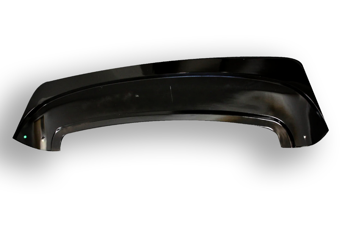A glossy black plastic car fender lies on a white surface, with a slightly curved shape and a small reflective highlight on one corner.
