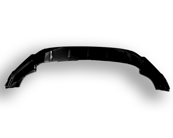 A black automotive bumper is resting on a plain white background, displaying curved edges and subtle detailing across its surface.