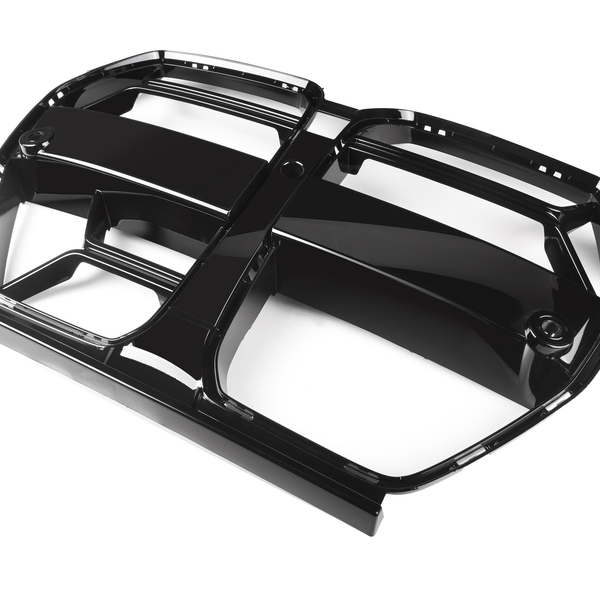 A glossy black car grill with bold lines and rectangular sections, oriented diagonally on a plain white background.