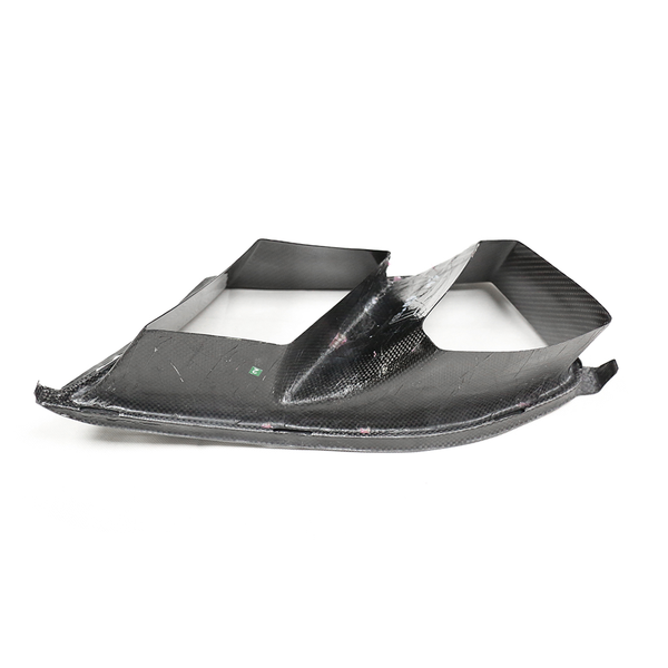 Black carbon fiber panel with angular, aerodynamic design; rests on a flat surface, showcasing its lightweight structure and modern engineering.