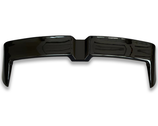 A glossy black car spoiler sits on a white background, reflecting overhead lights, highlighting its sleek, curved design and aerodynamic structure.