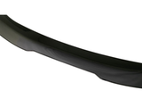 A glossy, black car bumper spoiler displayed against a white background, emphasizing its curved shape and sleek finish.