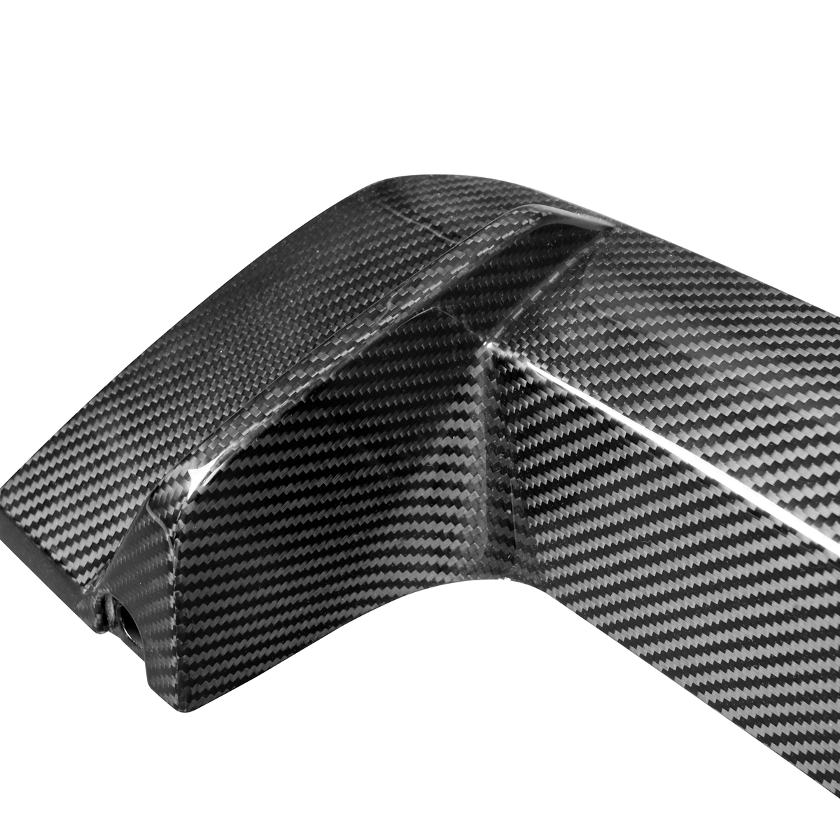 A carbon fiber car part, featuring a sleek, curved design with a glossy finish, lies against a plain white background.