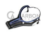Carbon fiber car interior trim piece with a blue accent, designed for dashboard integration. The piece lies on a white background with 