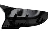 A black plastic car mirror cover features attachment clips on the interior surface, designed to fit over a vehicle's side mirror, set against a plain white background.