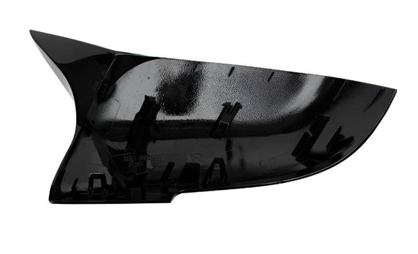 A glossy black plastic car mirror housing with multiple internal clips is viewed against a white background, showing its reflective surface and structure designed for attachment.