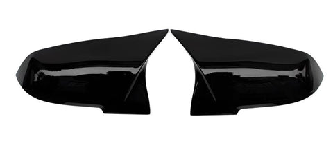 Two glossy black side mirror covers are positioned symmetrically, facing each other against a plain white background.